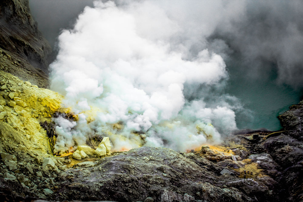 Toxic fumes coming out of the crater, miners go down to the bottom to extract sulphur.