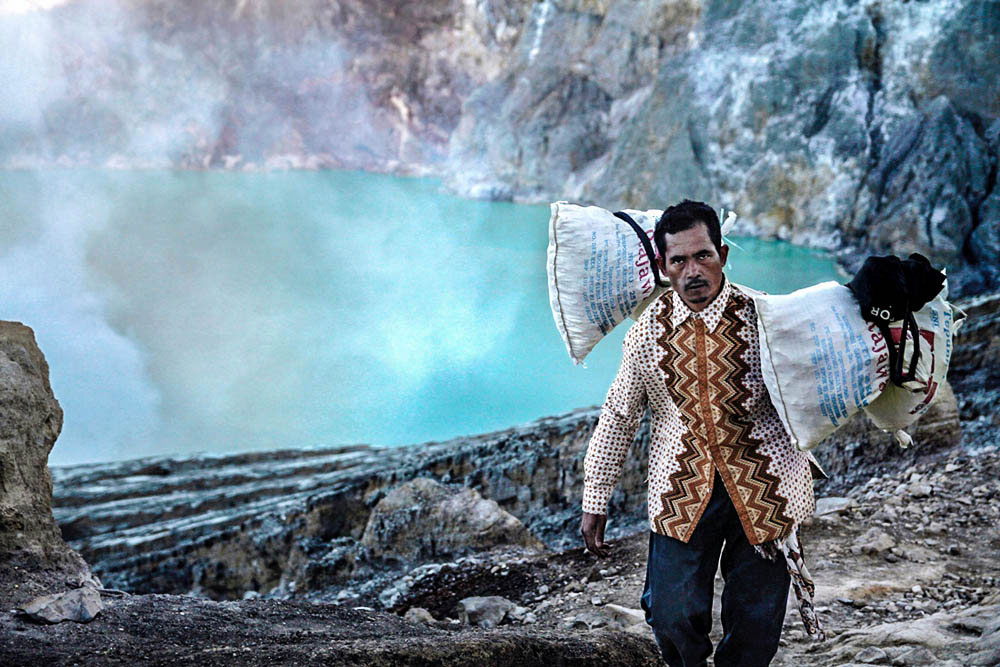 The quietly active volcano emits gases through fumaroles inside the crater which are highly toxic. Some miners don't wear any protection at all.