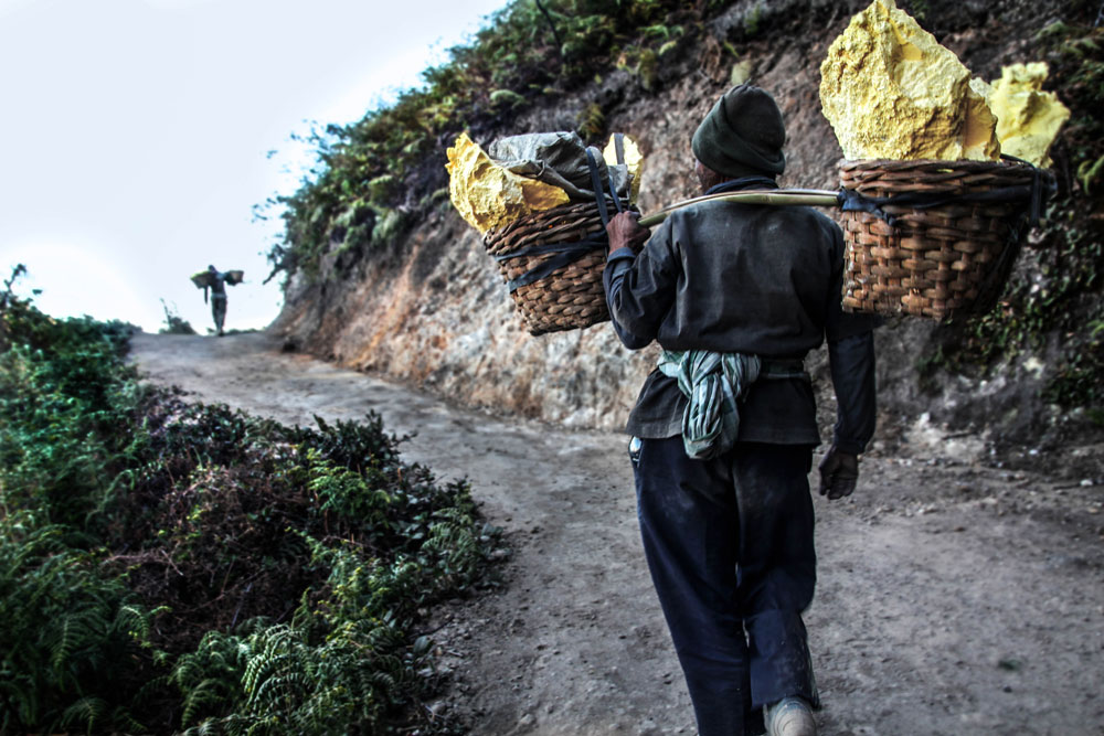 A heavy load carried upon miners' shoulders.
